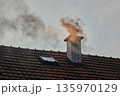 Smoking Chimney on a Roof 135970129
