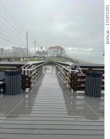 View of the entrance to the beach on rain. Destin, USA. View of the entrance to the beach on rain. Destin, USA. 135972201