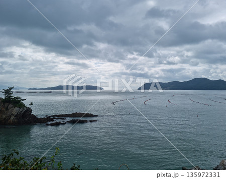 It is a seascape of Land End Village covered in dark clouds. 135972331