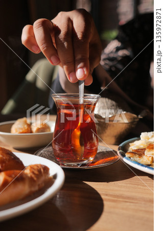 Enjoying Turkish tea and snacks in a cozy cafe setting 135972871