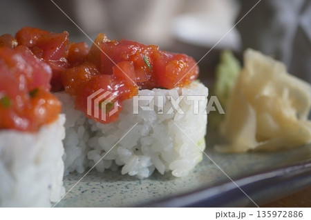 Enjoying sushi with fresh toppings at a local restaurant 135972886