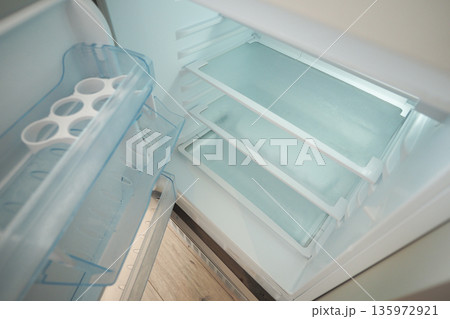 Fridge interior with empty shelves and ice tray Fridge interior with empty shelves and ice tray 135972921