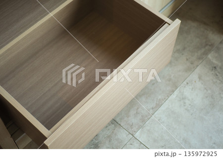 Wooden drawer opens to show empty space inside Wooden drawer opens to show empty space inside 135972925