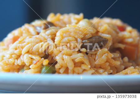 Bulgur Rice dish with vegetables on a white plate in a kitchen 135973038