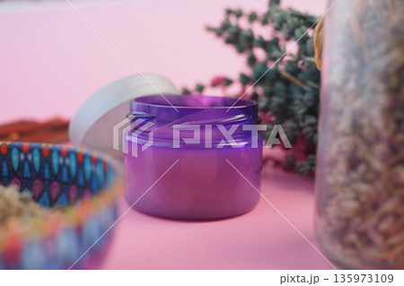 Purple Skincare Cream Jar on Pink Background with Decorative Bowl  135973109