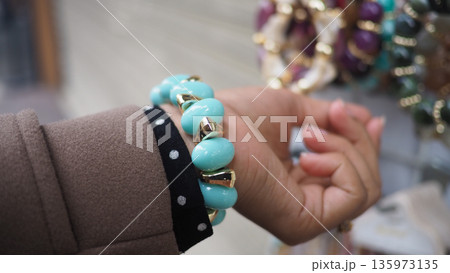 Hand with turquoise bracelet in a store display Hand with turquoise bracelet in a store display 135973135