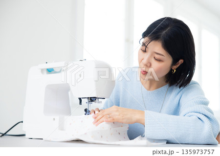 ミシンで裁縫している女性 ミシンで裁縫している女性 135973757