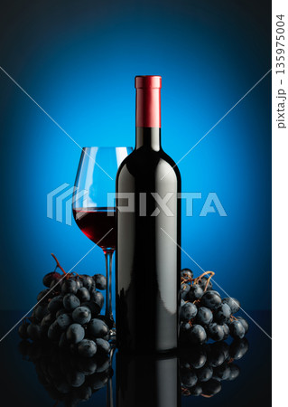 Red wine and juicy blue grapes. Red wine and juicy blue grapes. 135975004