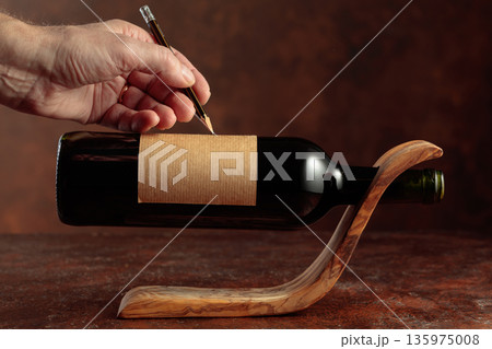 Bottle of red wine with empty label. Bottle of red wine with empty label. 135975008