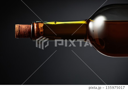 An almost opened bottle of white wine. An almost opened bottle of white wine. 135975017