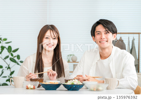 マイホームのダイニングテーブルで食事をする若いアジア人夫婦,カップル 135976392
