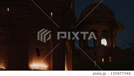 Full moon framed by arches of illuminated watchtower at Red Fort Delhi night scene Full moon framed by arches of illuminated watchtower at Red Fort Delhi night scene 135977348