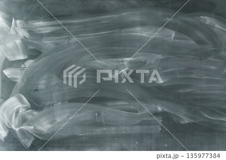 チョークの粉と消し跡が広がる緑色の黒板 チョークの粉と消し跡が広がる緑色の黒板 135977384