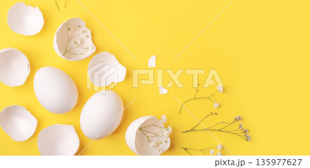 White Easter eggs and shells on a bright yellow background. 135977627