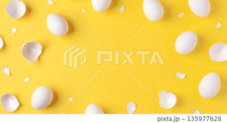 White Easter eggs and shells on a bright yellow background. 135977628