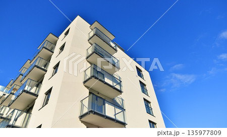 Apartment residential house and home facade architecture and outdoor facilities. Blue sky on the background. Sunlight in sunrise. Apartment residential house and home facade architecture and outdoor facilities. Blue sky on the background. Sunlight in sunrise. 135977809