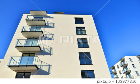 Apartment residential house and home facade architecture and outdoor facilities. Blue sky on the background. Sunlight in sunrise. Apartment residential house and home facade architecture and outdoor facilities. Blue sky on the background. Sunlight in sunrise. 135977810
