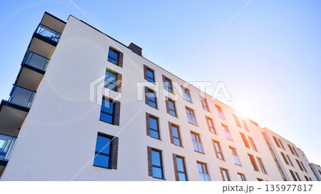 Apartment residential house and home facade architecture and outdoor facilities. Blue sky on the background. Sunlight in sunrise. Apartment residential house and home facade architecture and outdoor facilities. Blue sky on the background. Sunlight in sunrise. 135977817