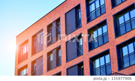 Apartment residential house and home facade architecture and outdoor facilities. Blue sky on the background. Sunlight in sunrise. Apartment residential house and home facade architecture and outdoor facilities. Blue sky on the background. Sunlight in sunrise. 135977906