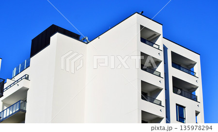 Apartment residential house and home facade architecture and outdoor facilities. Blue sky on the background. Sunlight in sunrise. Apartment residential house and home facade architecture and outdoor facilities. Blue sky on the background. Sunlight in sunrise. 135978294