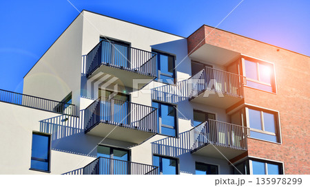 Apartment residential house and home facade architecture and outdoor facilities. Blue sky on the background. Sunlight in sunrise. Apartment residential house and home facade architecture and outdoor facilities. Blue sky on the background. Sunlight in sunrise. 135978299