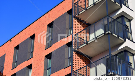 Apartment residential house and home facade architecture and outdoor facilities. Blue sky on the background. Sunlight in sunrise. Apartment residential house and home facade architecture and outdoor facilities. Blue sky on the background. Sunlight in sunrise. 135978352