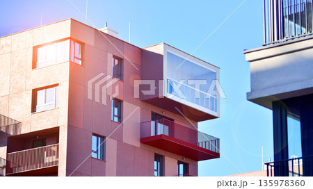 Apartment residential house and home facade architecture and outdoor facilities. Blue sky on the background. Sunlight in sunrise. Apartment residential house and home facade architecture and outdoor facilities. Blue sky on the background. Sunlight in sunrise. 135978360