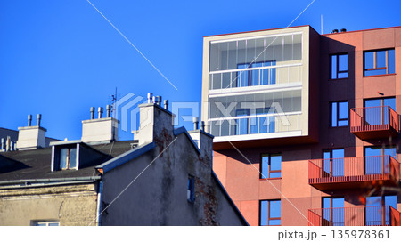 Apartment residential house and home facade architecture and outdoor facilities. Blue sky on the background. Sunlight in sunrise. Apartment residential house and home facade architecture and outdoor facilities. Blue sky on the background. Sunlight in sunrise. 135978361
