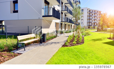 Apartment residential house and home facade architecture and outdoor facilities. Blue sky on the background. Sunlight in sunrise. Apartment residential house and home facade architecture and outdoor facilities. Blue sky on the background. Sunlight in sunrise. 135978567