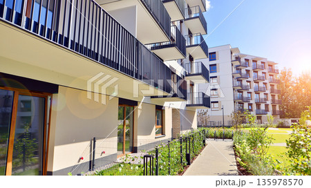Apartment residential house and home facade architecture and outdoor facilities. Blue sky on the background. Sunlight in sunrise. Apartment residential house and home facade architecture and outdoor facilities. Blue sky on the background. Sunlight in sunrise. 135978570