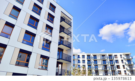 Apartment residential house and home facade architecture and outdoor facilities. Blue sky on the background. Sunlight in sunrise. Apartment residential house and home facade architecture and outdoor facilities. Blue sky on the background. Sunlight in sunrise. 135978613