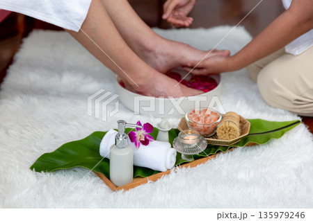 Man indulges in blissful foot massage at luxurious spa salon. Quiescent Man indulges in blissful foot massage at luxurious spa salon. Quiescent 135979246