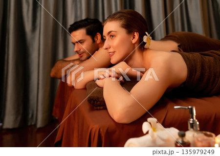 Caucasian couple customer enjoying relaxing anti-stress massage. Quiescent Caucasian couple customer enjoying relaxing anti-stress massage. Quiescent 135979249