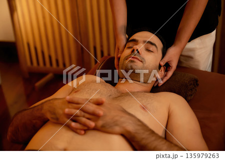 Caucasian man enjoying relaxing anti-stress head massage. Quiescent Caucasian man enjoying relaxing anti-stress head massage. Quiescent 135979263