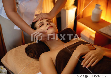Caucasian woman enjoying relaxing anti-stress head massage. Quiescent Caucasian woman enjoying relaxing anti-stress head massage. Quiescent 135979375