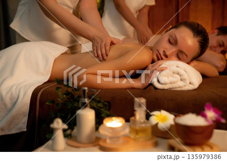 Caucasian couple customer enjoying relaxing anti-stress massage. Quiescent Caucasian couple customer enjoying relaxing anti-stress massage. Quiescent 135979386