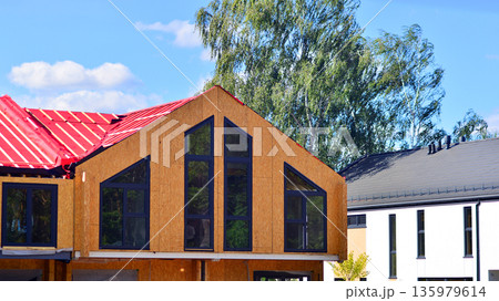 Terraced houses under construction. Housing estate development under construction.   135979614