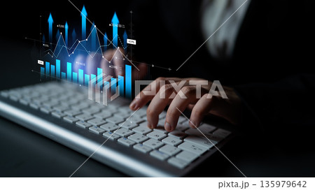 Professional hand typing on keyboard with data analytics graph overlay representing business growth, statistical trends, and digital technology concepts. Scalp Professional hand typing on keyboard with data analytics graph overlay representing business growth, statistical trends, and digital technology concepts. Scalp 135979642