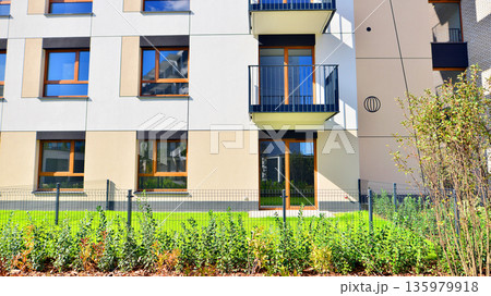 The garden of a modern residential building with a green lawn and a place to relax. Home garden. 135979918