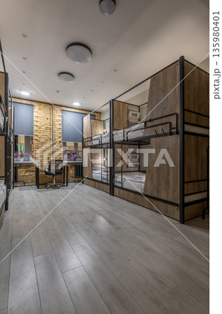Evening view of a modern loft hostel dormitory with bunk beds Evening view of a modern loft hostel dormitory with bunk beds 135980401