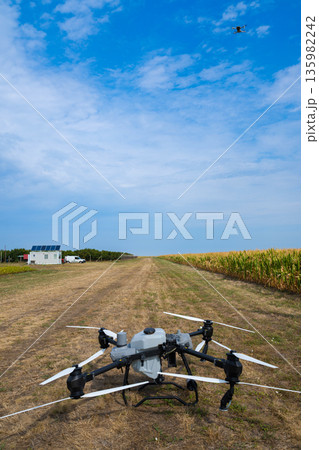 Drone on a rural field preparing for agricultural mapping and aerial inspection Drone on a rural field preparing for agricultural mapping and aerial inspection 135982242