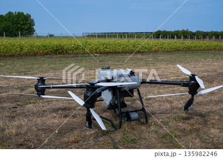 Agricultural drone on a dry field ready for aerial inspection and data capture 135982246
