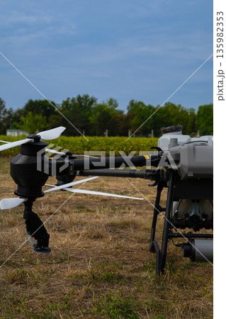Agricultural drone in field with mounted equipment and propellers for aerial crop inspection 135982353