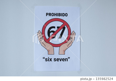 Sign on the white wall prohibition meme phrase six seven in Spanish 135982524