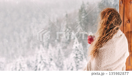 Woman Enjoying Connection with Nature and Winter Landscape 135982877