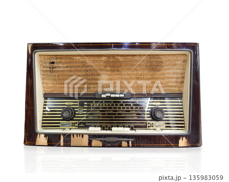 A vintage, retro radio receiver isolated from a white background, front view. 135983059