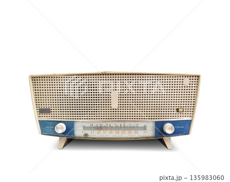 An antique cream and blue radio sits on a white floor. An antique cream and blue radio sits on a white floor. 135983060
