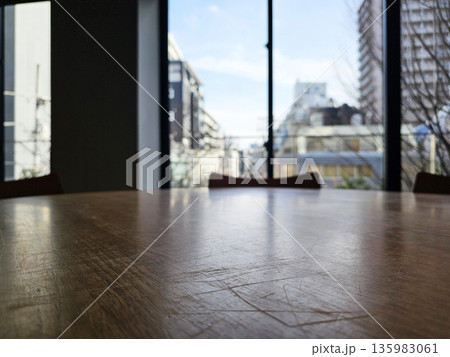 Close up Surface of Wooden Table in Cafe with View of Tokyo City Buildings in the winter Background. Close up Surface of Wooden Table in Cafe with View of Tokyo City Buildings in the winter Background. 135983061
