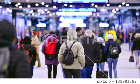 Warsaw, Poland. 28 November 2025. Commuters going through the underground passage hall at Warszawa Zachodnia train station. Ceiling mounted large artificial illumination. 135983368