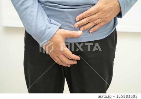 Hernia, Asian man stomach ache, abdominal pain and urology problem health. 135983605
